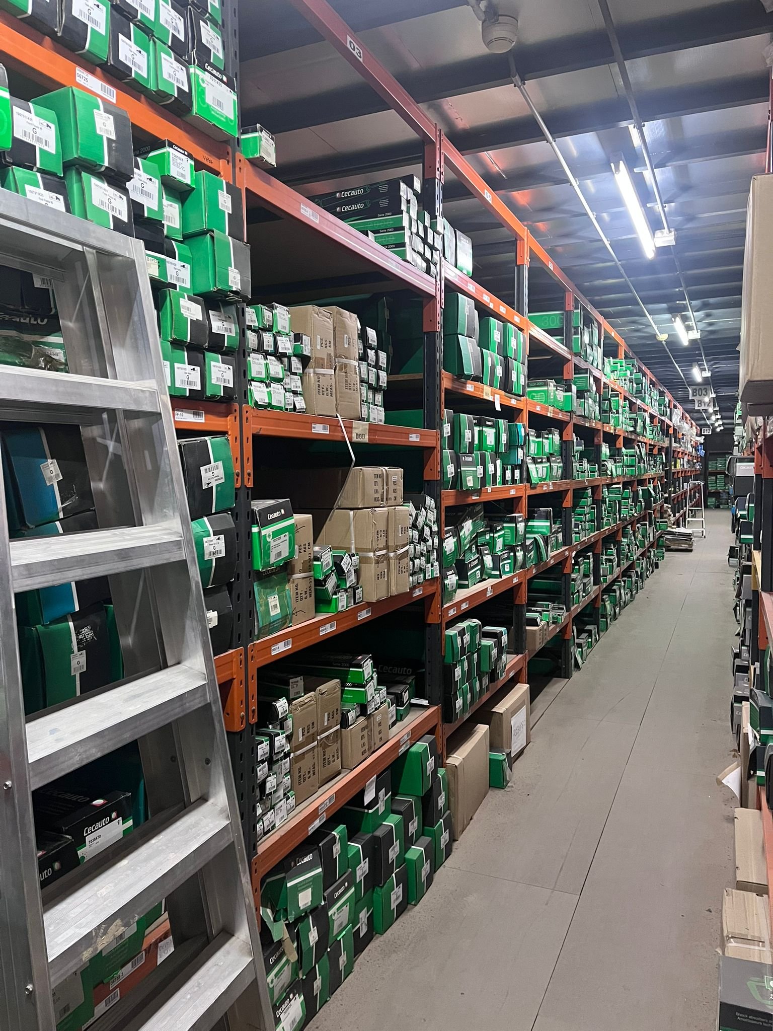 Warehouse aisle with Cecauto branded boxes