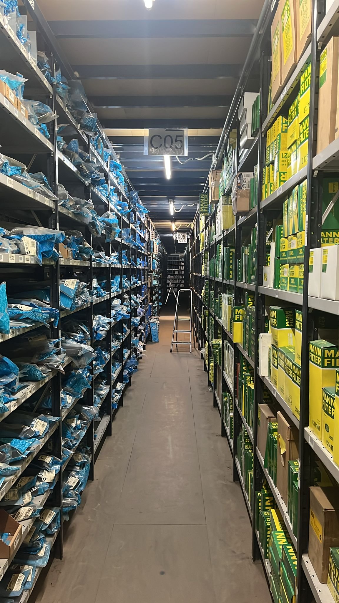 Long warehouse aisle with parts shelving on both sides