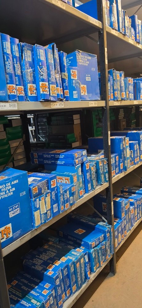 Warehouse aisle with shelves of boxed automotive parts