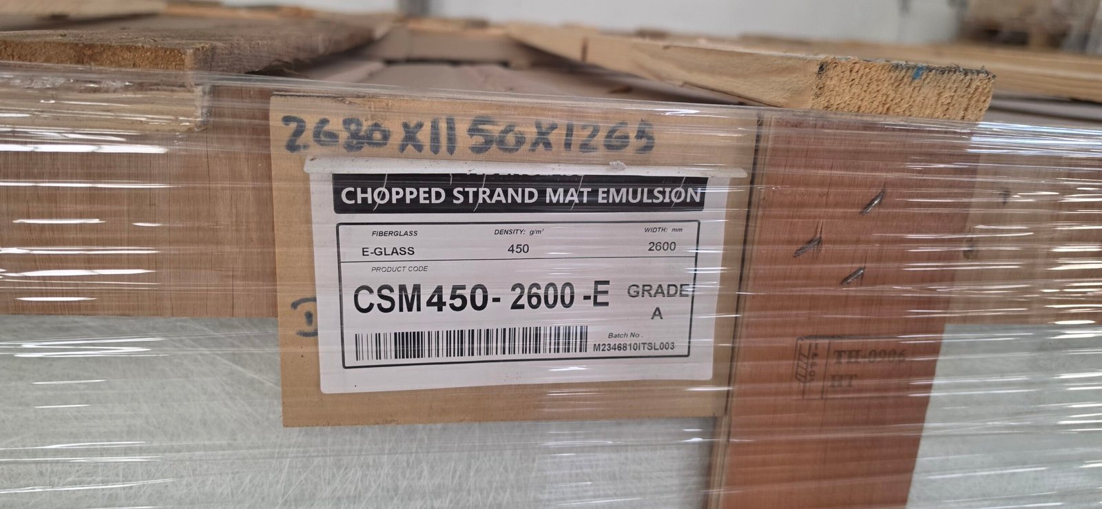 Wooden crate marked with dimensions containing fiberglass rolls