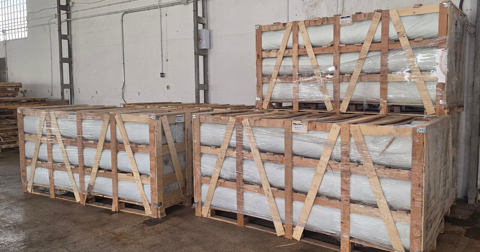 Fiberglass mat roll crates stacked in warehouse
