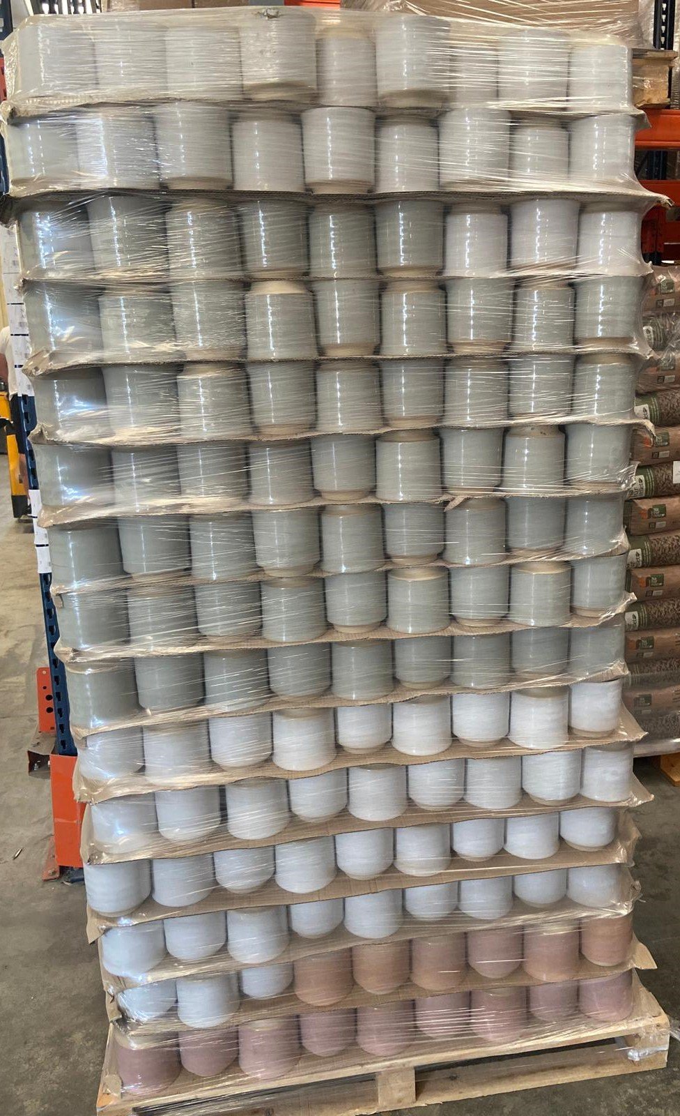 Pallet of glazed stoneware flowerpots, grey and pink glaze