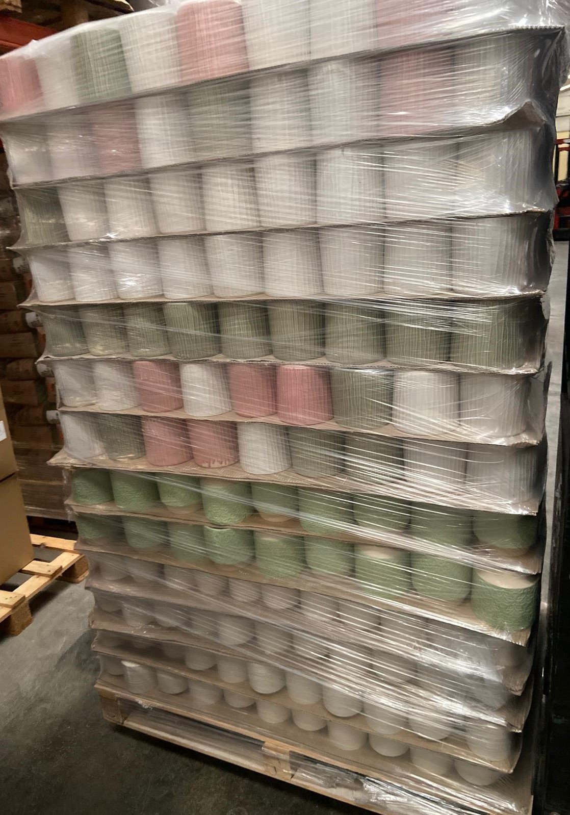 Pallet of glazed stoneware flowerpots, assorted pink, green and white glaze