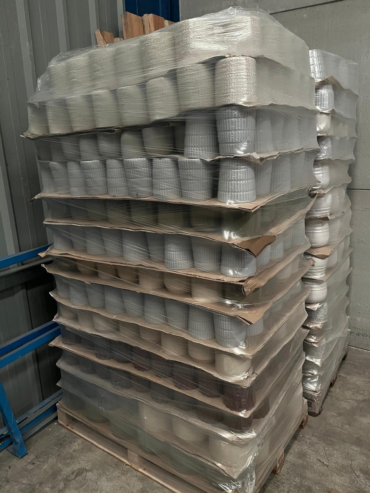 Pallets of glazed stoneware flowerpots, close view