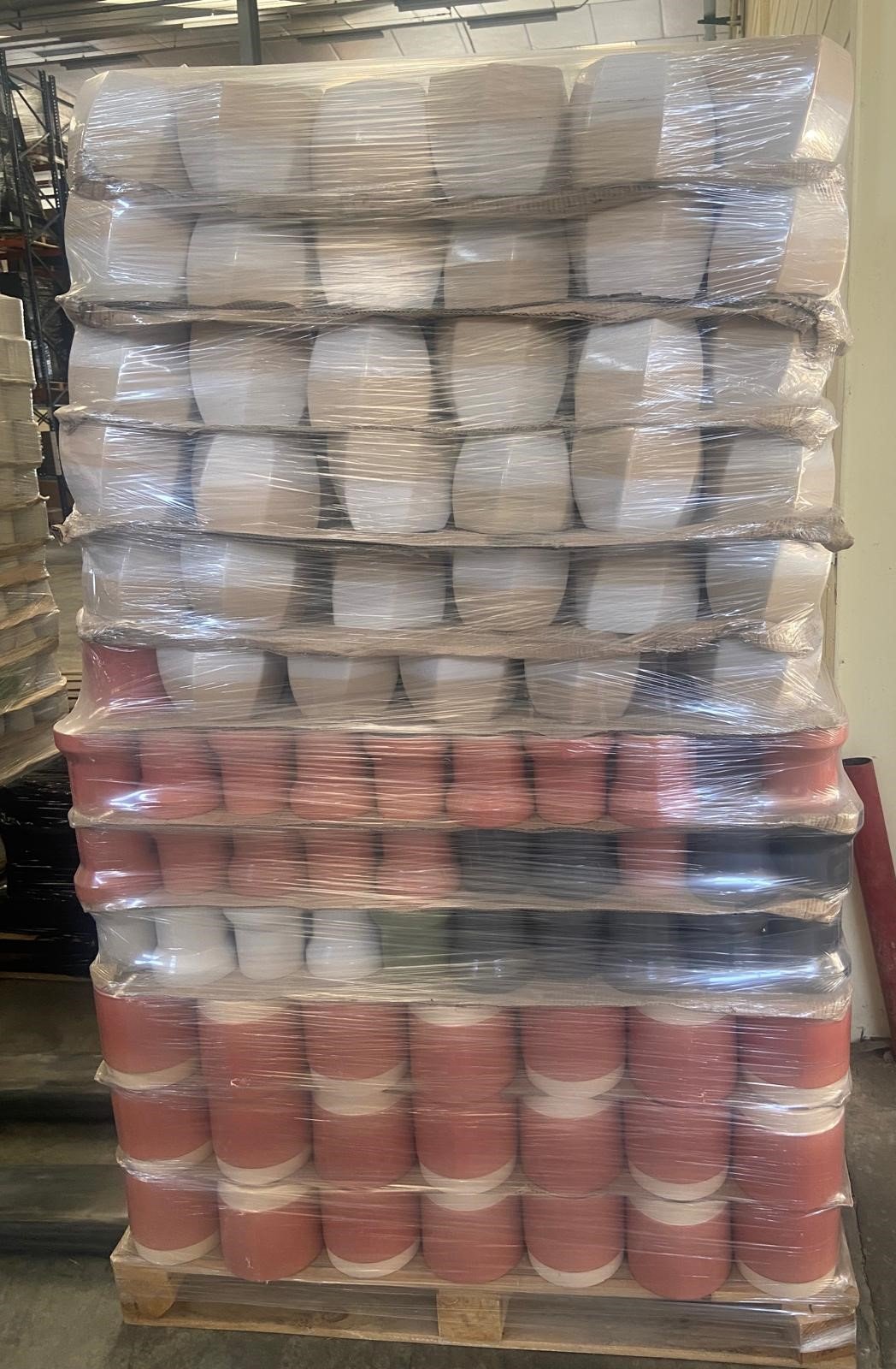 Pallet of glazed stoneware flowerpots, mixed white and terracotta glaze